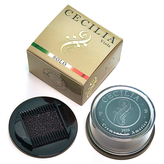 Viola rosin, contained in a clear plastic container with a black base, sits next to its gold and green box.  The box is labeled "CECILIA Viola SOLO".